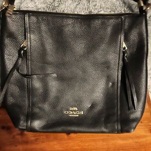 Black leather Coach bag with conceal pockets on front. Zipper closure